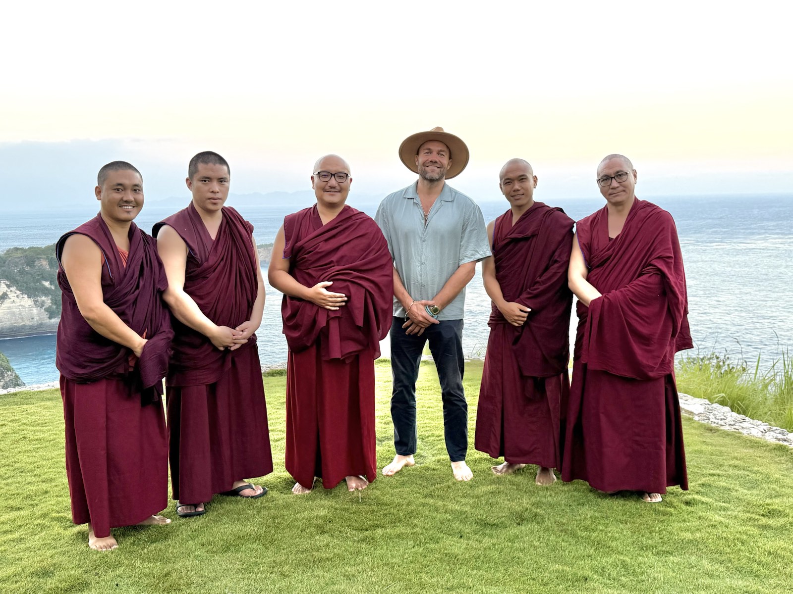 Edward Sczudlo with five monks beside the coast during the Indonesia tour