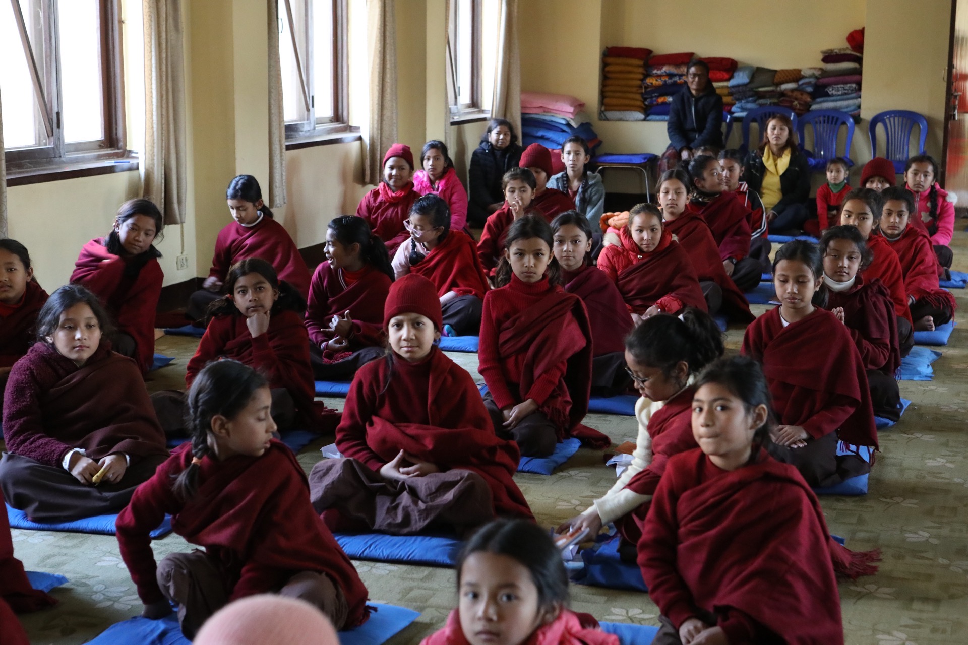 Young community members gathered in a hall