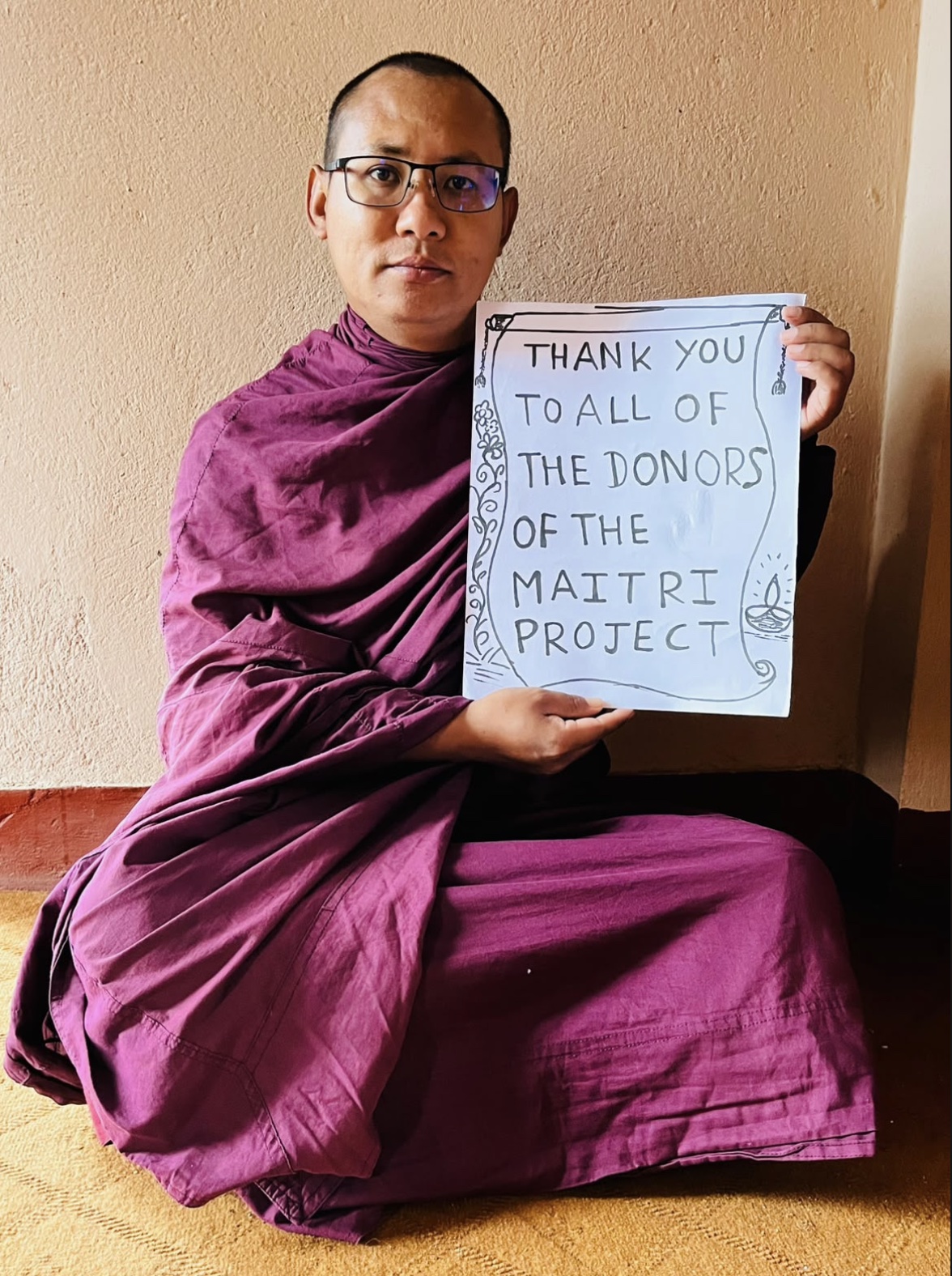 A monastic sharing thanks with Maitri donors