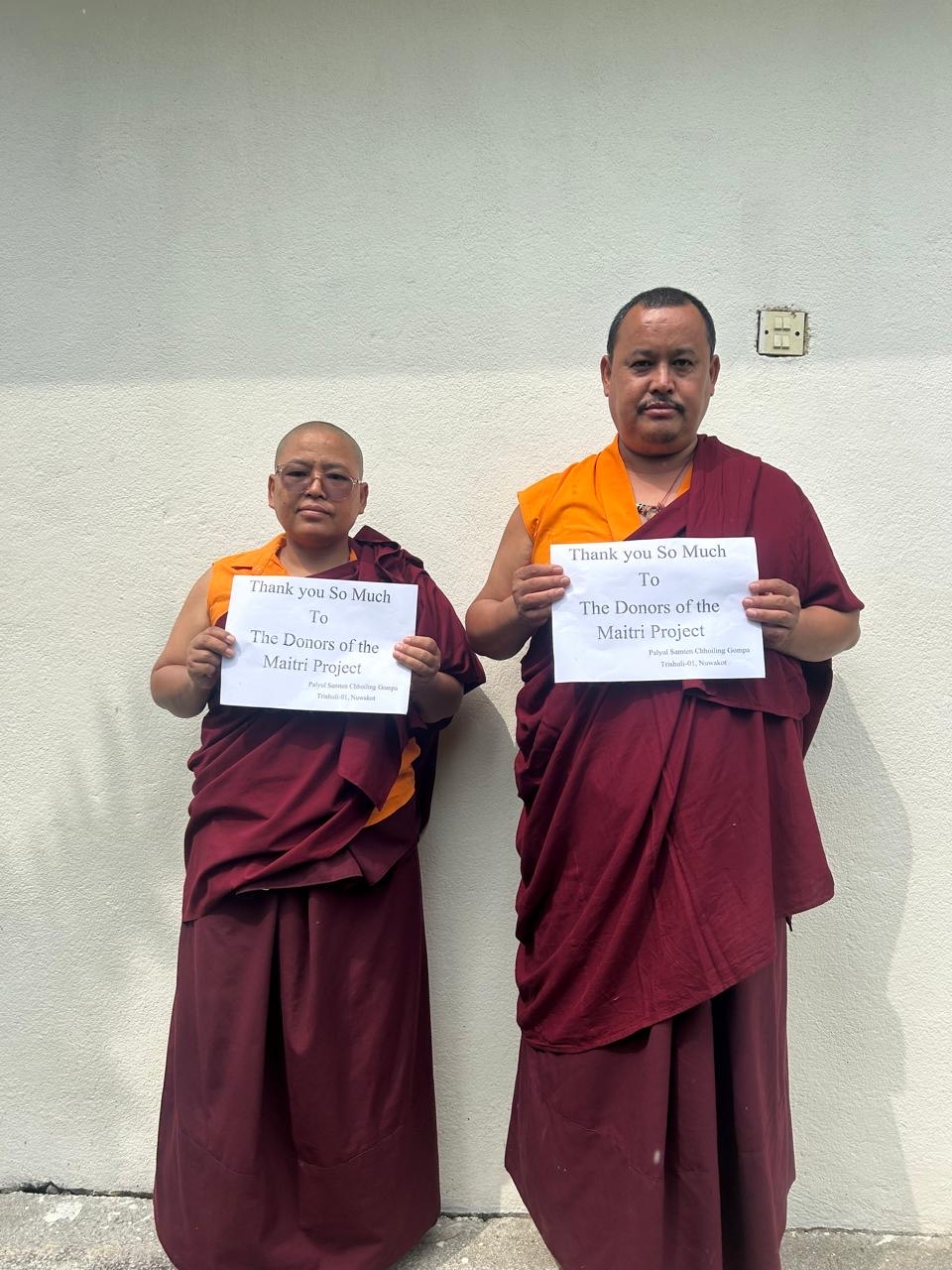 Two monastics sharing thanks with Maitri donors