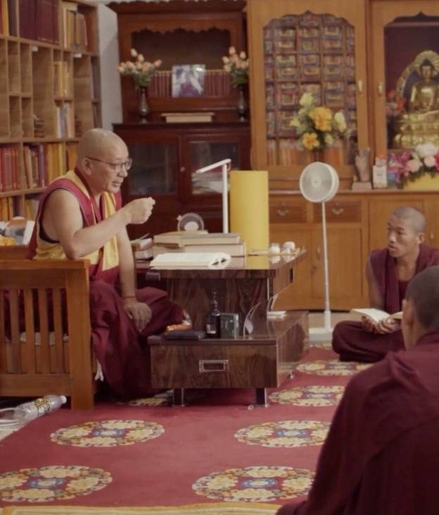 A teacher guiding students in the monastery
