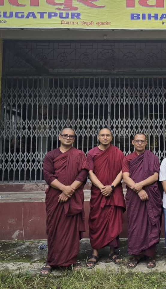Monastics standing together outside a community vihara