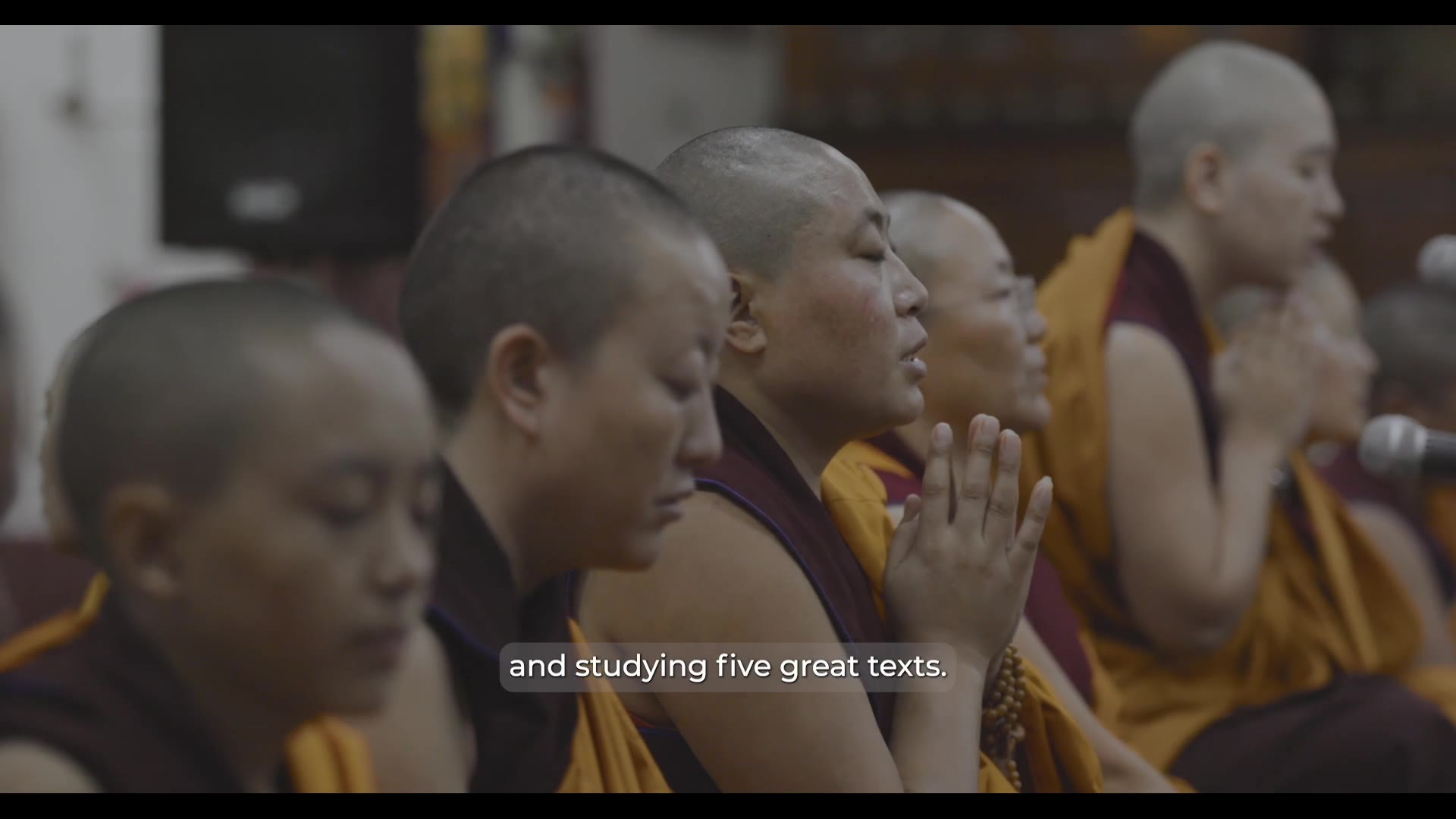 Nuns gathered in prayer — still from Rise of the Geshe-Ma
